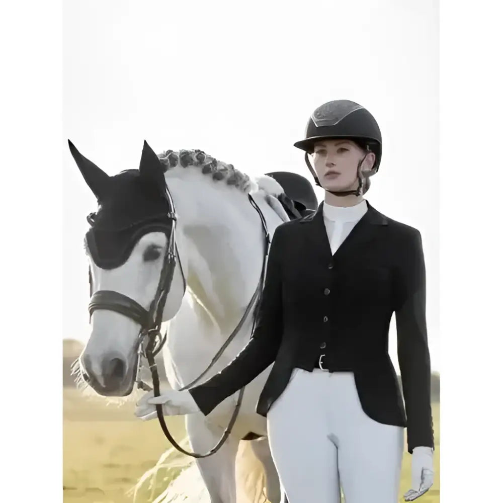Black lemieux zoe equestrian helmet with matte finish and subtle branding perfect for dressage competition wear