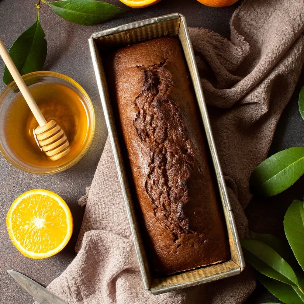 Rich dark chocolate loaf cake in a vintage metal pan, perfect for a lemon drizzle cake or drizzle cake treat