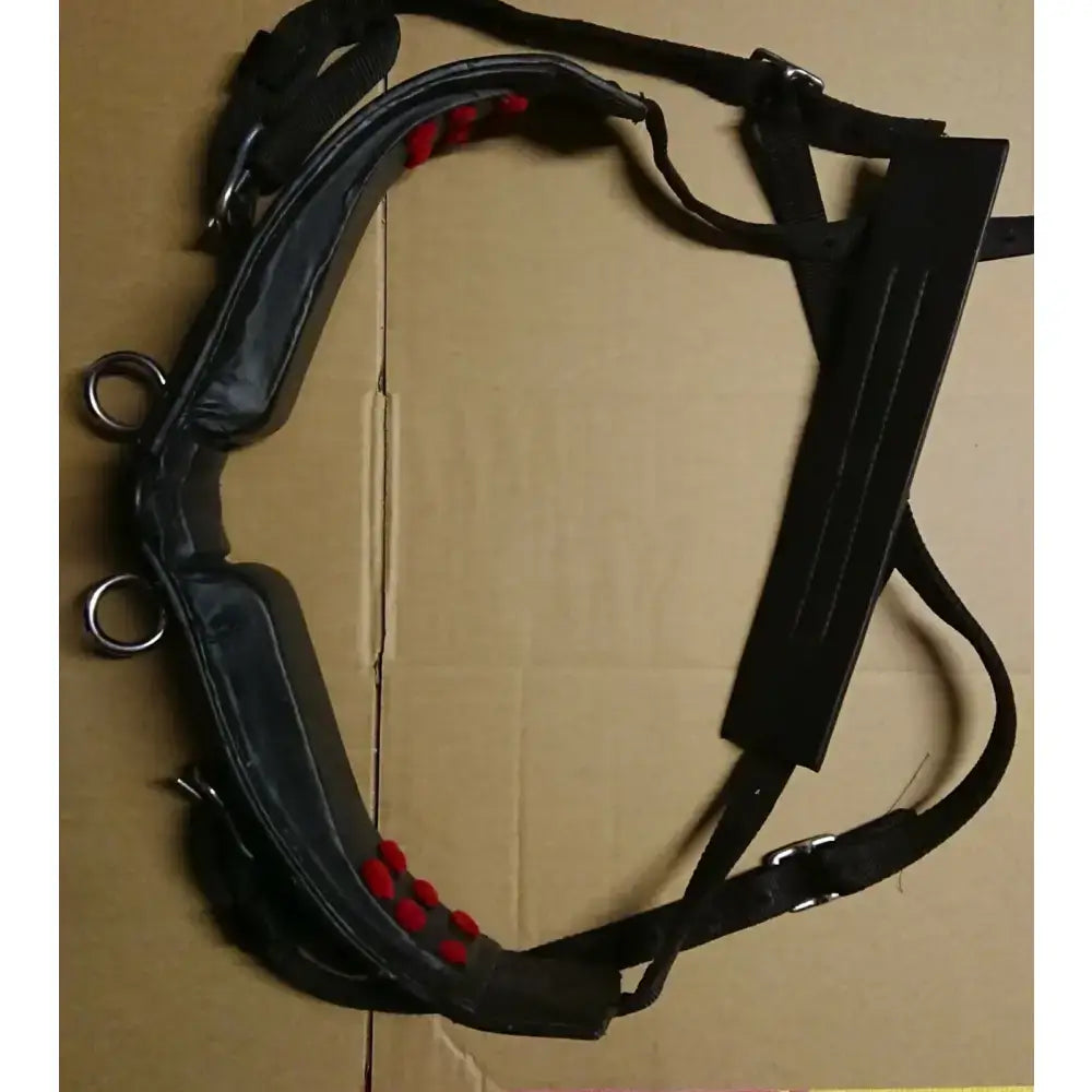 Black leather libbys driving saddle harness parts with red padded accents metal hardware and webbing tugs belly band