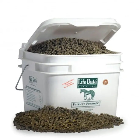 White plastic bucket of life data farriers formula 5kg filled with dark brown cylindrical pellets for horses