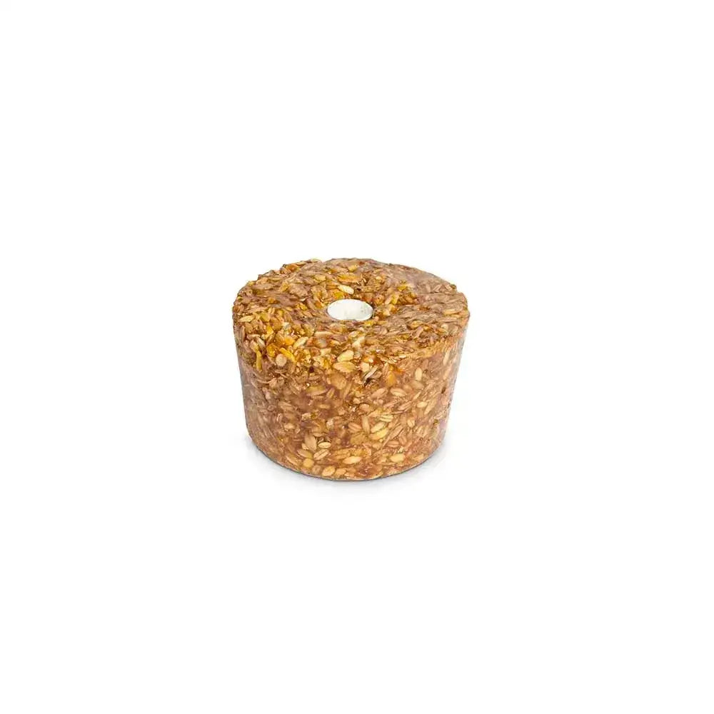 A cylindrical golden brown likit granola multigrain apple bird treat with a central hole and rock hard formulation
