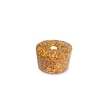 A cylindrical golden brown likit granola multigrain apple bird treat with a central hole and rock hard formulation