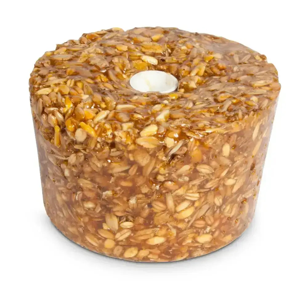 A cylindrical golden-brown likit granola bird treat made of oats and honey with rock hard formulation prolongs playtime