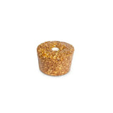 A cylindrical golden-brown oat based candle with a white wick for likit granola multigrain molasses rock hard formulation