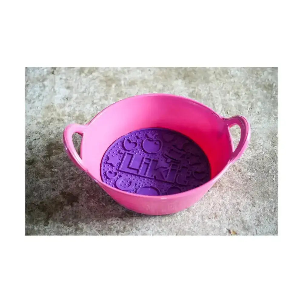 Pink silicone likit graze maze bowl with two handles and purple interior slow feeding lick design