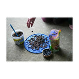 Blue circular likit graze paste cleaning mat with textured surface and raised bumps for tasty licking paste use