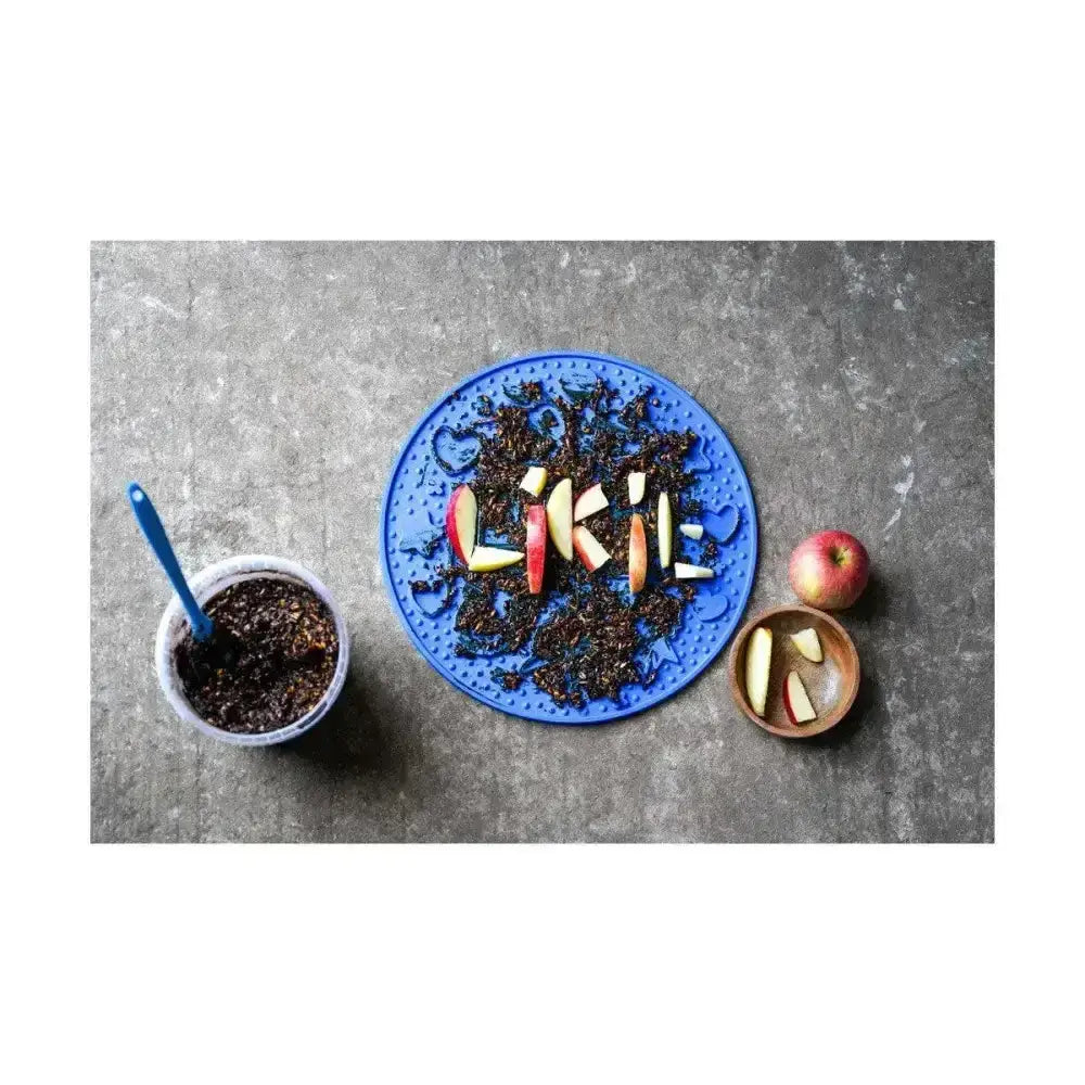 Blue silicone plate with apple slices spelling liki showcasing tasty licking paste like likit graze paste
