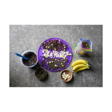 Purple circular silicone mixing mat with star-shaped cutouts and scattered ingredients for likit graze paste use