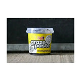 Yellow plastic tub of likit graze paste with clear lid and cartoon horse logo tasty licking paste for horses
