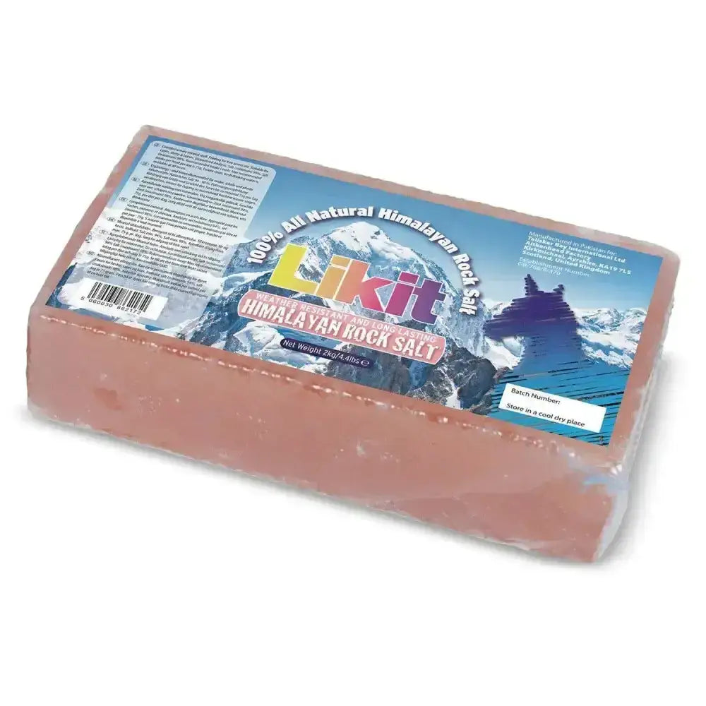 A rectangular block of pink himalayan rock salt lick in clear plastic with a colorful mountain label by likit
