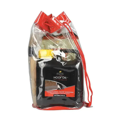 Red seasonal drawstring bag with black incognito hoof oil bottle and yellow cap in lincoln christmas gift bag