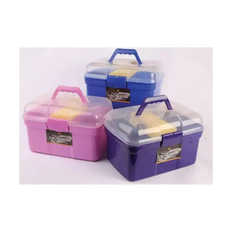 Three colorful lincoln grooming kit plastic cases with transparent lids and handles in pink blue and purple with brushes