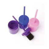 Purple plastic lincoln hoof oil brush with black bristles resting next to a matching open container oil brush complete