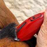 Red liveryman nova trimmer with textured grip and black button electric horse clipper for easy grooming