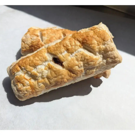 Golden brown flaky ljs pantry sausage roll with lattice top and dark filling perfect for tasty pantry sausage rolls