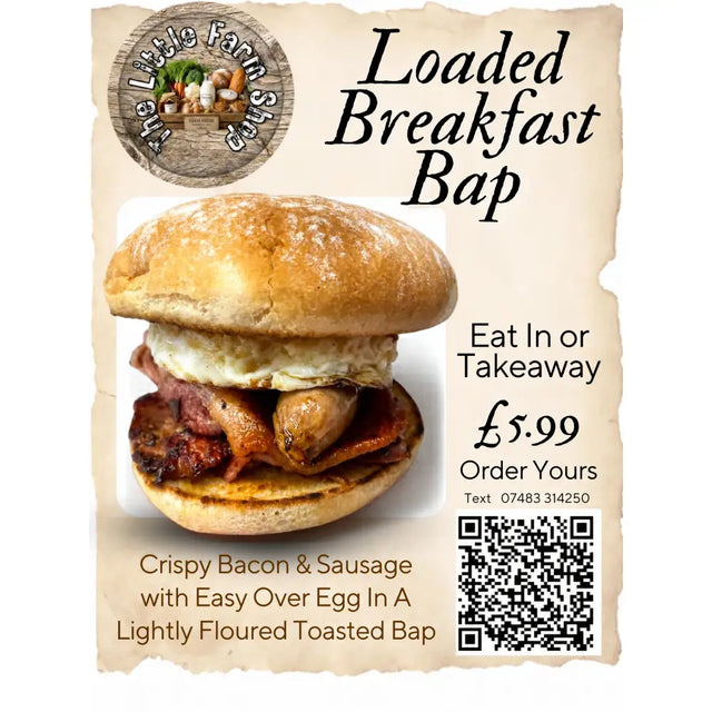 A loaded breakfast bap with golden toasted bap filled with crispy bacon, sausage, and a fatty acids rich egg topping