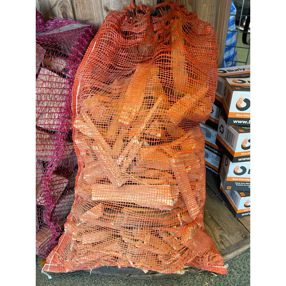 Orange mesh bag filled with locally cut kindling firewood perfect for camping or fireplaces