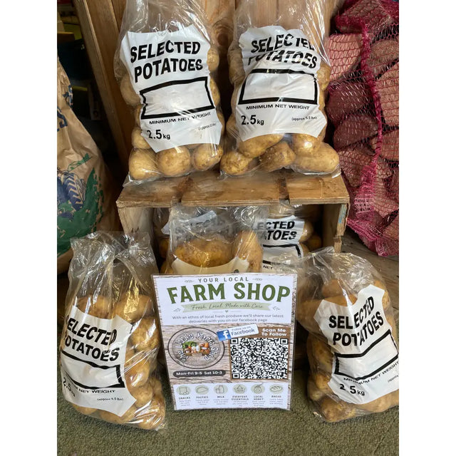 Clear plastic bags filled with locally grown wilja potatoes labeled selected potatoes 2.5kg net weight