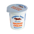 Longley farm soured cream in white plastic cup with orange blue label and brown cow logo similar to olympus greek yogurt packaging