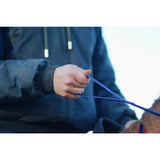 A hand holding royal blue nylon loop handled reins leading to a brown fur animal in libbys loop handled style