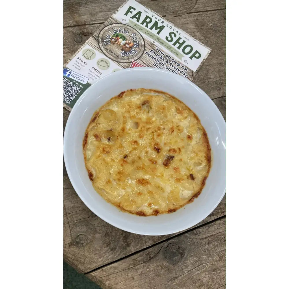 Golden-brown mac-n-cheese in a white ceramic bowl perfect for barnstaple equestrian supplies snack breaks