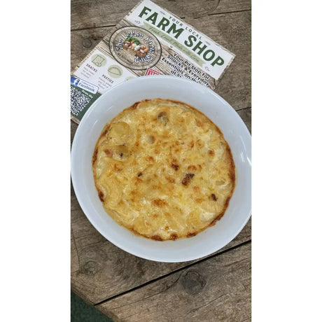 Golden-brown mac-n-cheese in a white ceramic bowl perfect for barnstaple equestrian supplies snack breaks