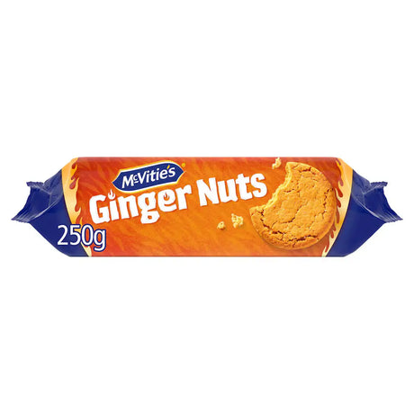 A pack of mcvities ginger nuts wrapped in bright orange and blue foil with a bite taken from the golden biscuit front