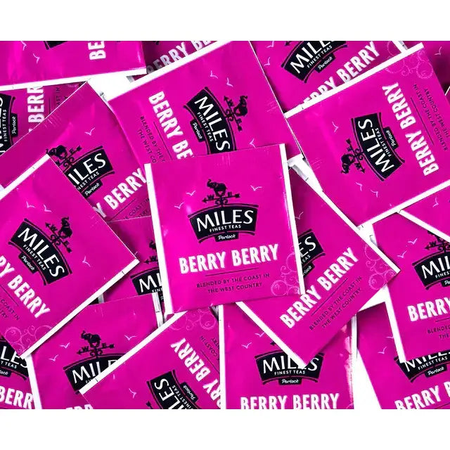 Bright pink packets of miles tea berry berry envelope teabags with coffee berry flavor for easy brewing