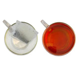 A clear glass tea cup with brewed earl grey tea made from miles tea earl teabags with italian bergamot oil
