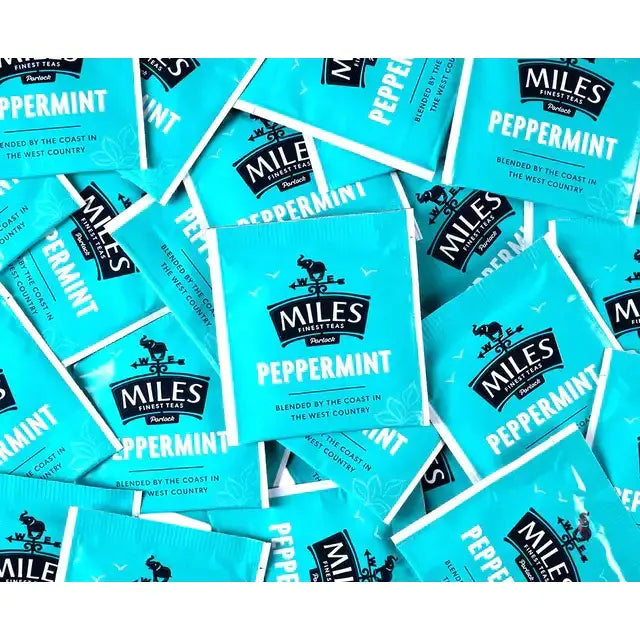 Bright turquoise miles tea envelope peppermint teabags with black branding and real peppermint leaves for fresh tea