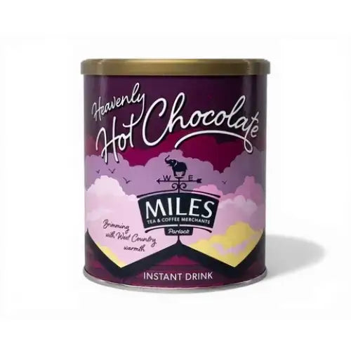 A purple cylindrical tin of miles heavenly hot chocolate with a gold lid and whimsical cloud design for coffee hot chocolate fans