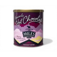 A purple cylindrical tin of miles heavenly hot chocolate with a gold lid and whimsical cloud design for coffee hot chocolate lovers