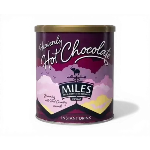A purple cylindrical tin of miles heavenly hot chocolate with a gold lid and whimsical cloud design for coffee hot chocolate lovers