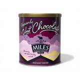 A purple cylindrical tin of miles heavenly hot chocolate with a gold lid and whimsical cloud design for coffee hot chocolate lovers