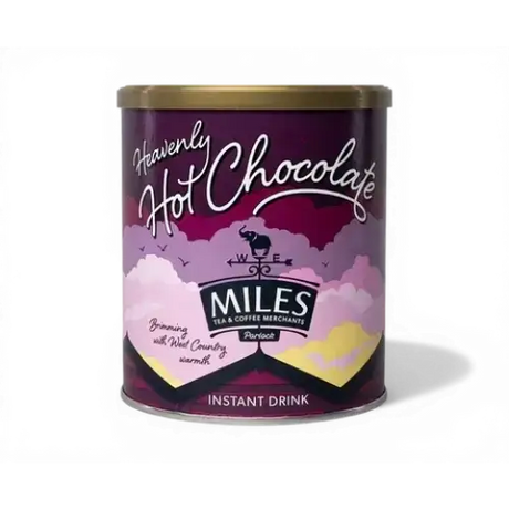 A purple cylindrical tin of miles heavenly hot chocolate with a gold lid and whimsical cloud design for coffee hot chocolate lovers