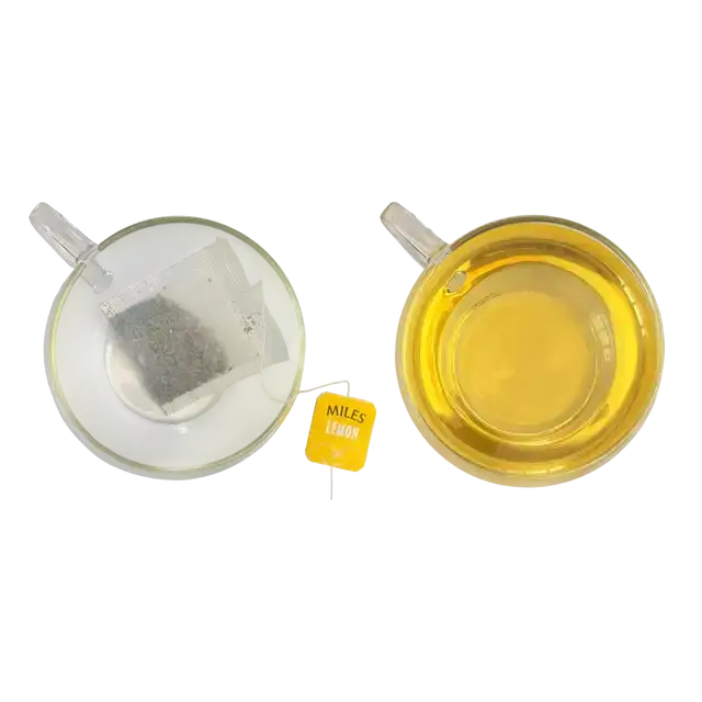 A yellow miles tea lemon envelope teabag with black text and loose dark tea inside a clear plastic pouch with lemon verbena