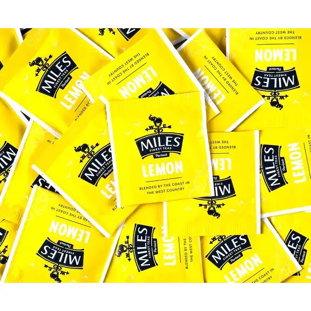 Bright yellow miles tea lemon envelope teabags with black logo on glossy packs featuring lemon verbena flavor