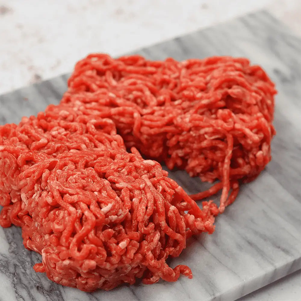 Fresh vibrant red minced beef with coarse texture and fat marbling perfect for high-quality meat dishes