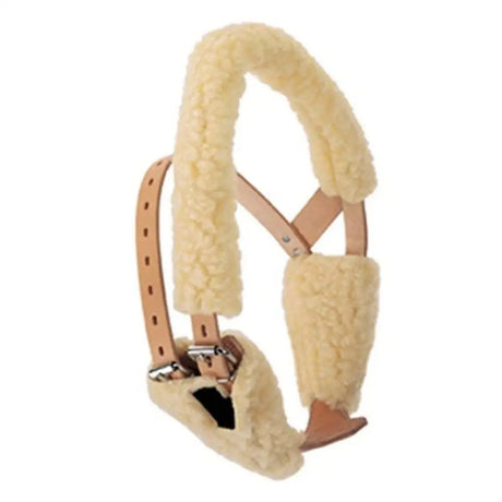 Cream-colored miracle collar fleece cover with sheepskin lining, tan leather straps, and silver metal hardware