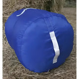 Blue cylindrical moorland rider hay carry bag with white zipper and reflective strip and base emptying handle