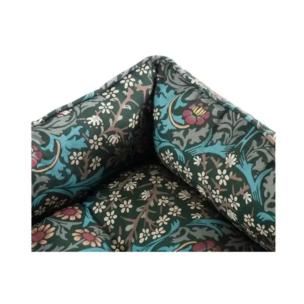 Dark green embroidered cushion with vibrant turquoise pink and white floral print on morris & co blackthorn print square bed