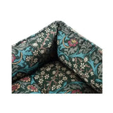 Dark green embroidered cushion with vibrant turquoise pink and white floral print on morris & co blackthorn print square bed