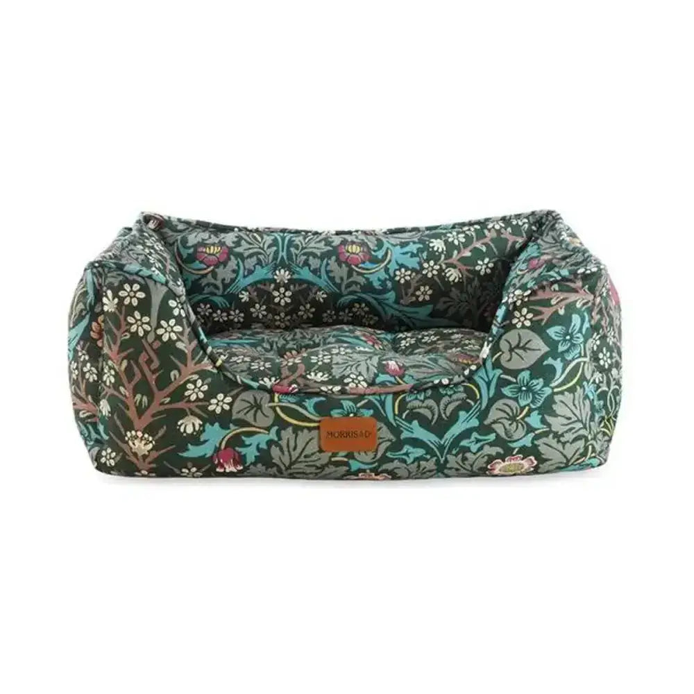 A plush dark green blackthorn print square pet bed with intricate floral accents in teal pink white and brown