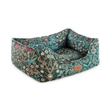 A plush rectangular pet bed in dark green fabric with intricate teal pink and white blossoms blackthorn print square bed