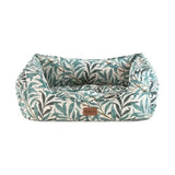 A cozy rectangular pet bed with morris and co willow boughs print fabric in green and cream tones