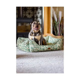 A plush olive-green and cream leaf-patterned dog bed with soft fabric finish featuring morris & co willow boughs print