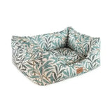 A cozy rectangular pet bed upholstered in soft fabric with morris & co willow boughs print in green and gray on cream