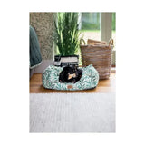 A cozy rectangular dog bed with soft green and white fabric featuring morris & co willow boughs print design