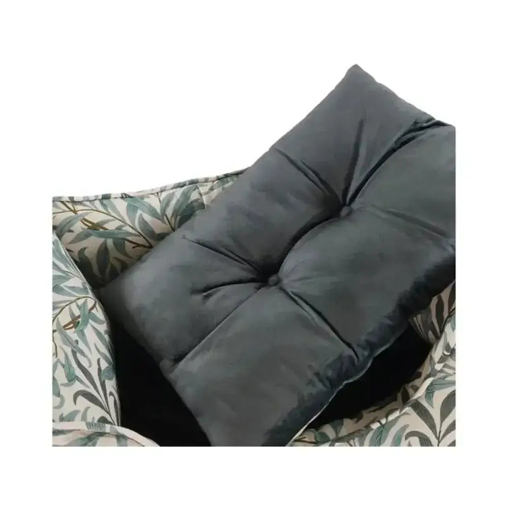 Dark gray tufted cushion with plush velvet texture and button details for morris and co bed willow boughs print