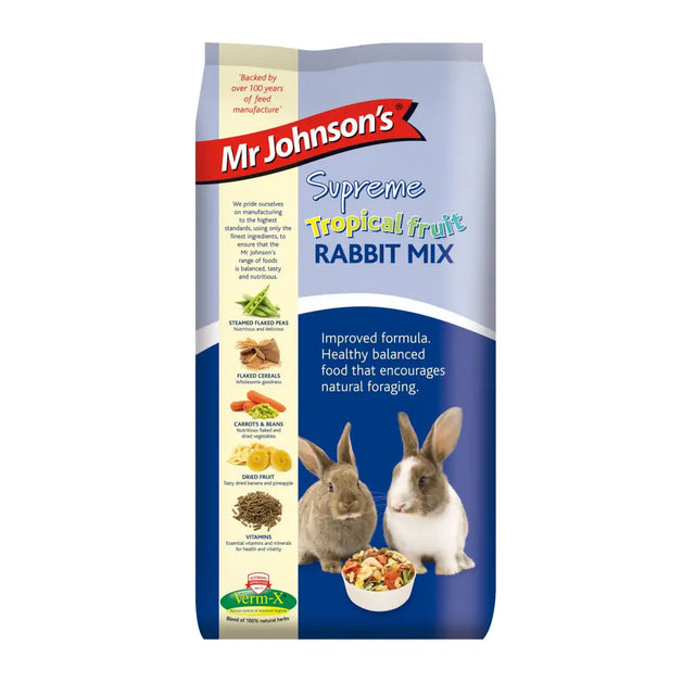 A blue and white bag of johnsons supreme fruit rabbit 15 kg with images of rabbits steamed peas and dried fruit